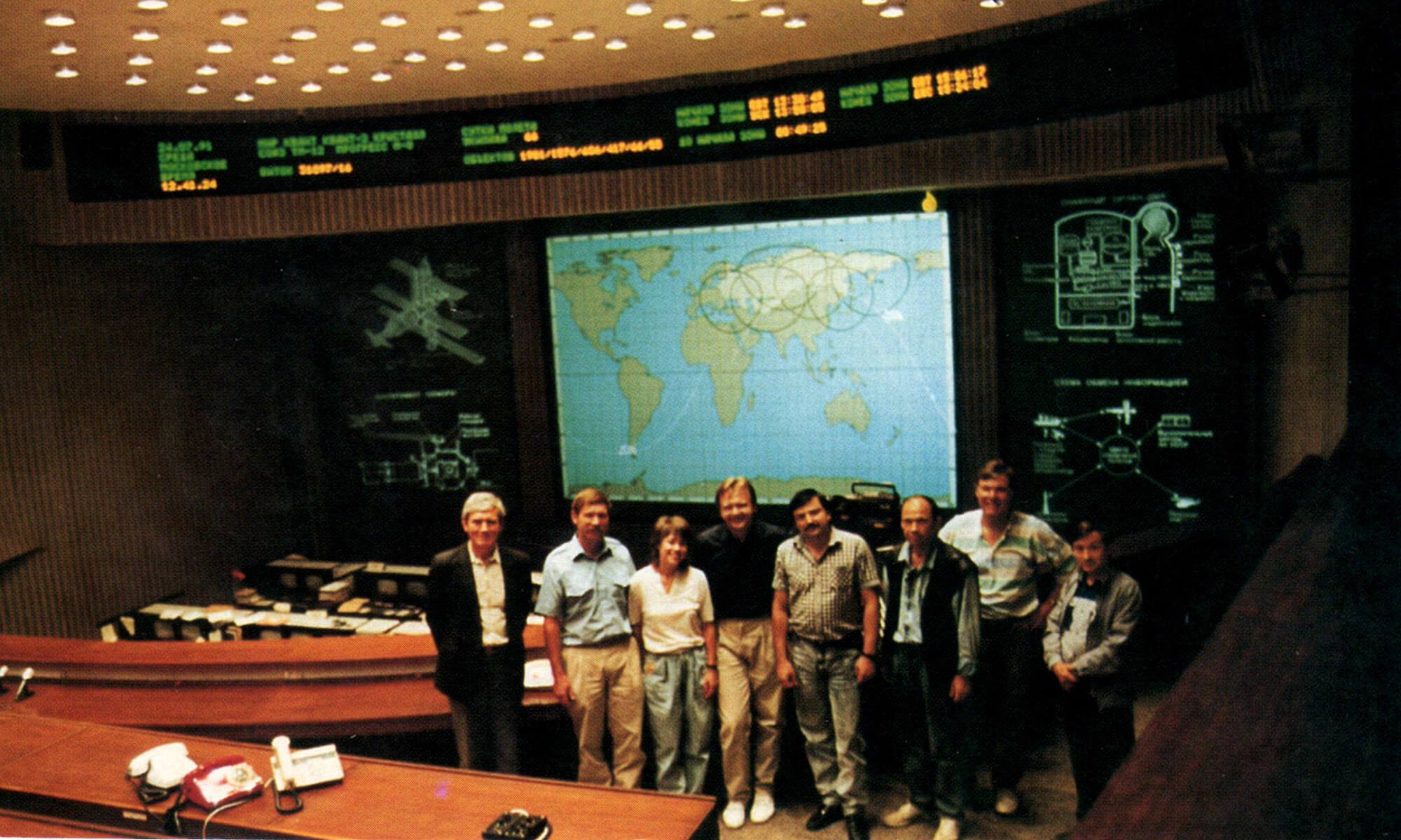 The flight crew and officials at the Soviet Mission Control Center in Moscow.